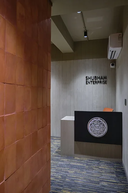 Reception signage on textured terracotta tile wall