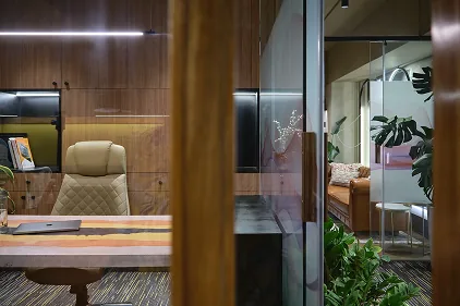 Reflected view into a private office pod and lounge