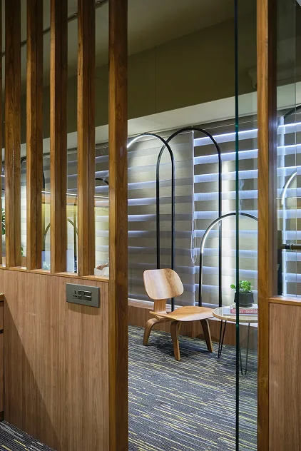 Timber slat partition screening the arched lounge