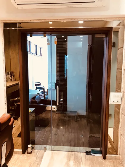 Glass entrance door reflecting the salon interior