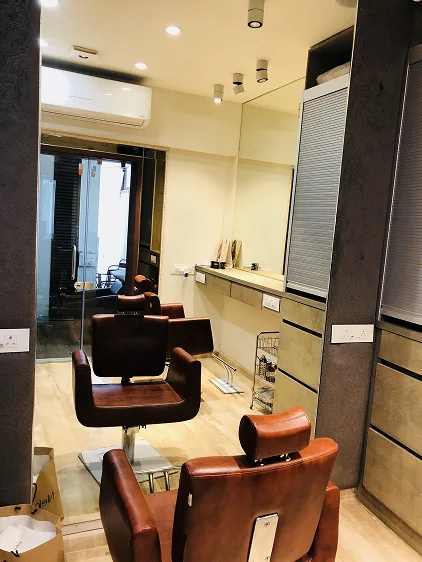 Styling chairs beside the mirrored corridor to the terrace