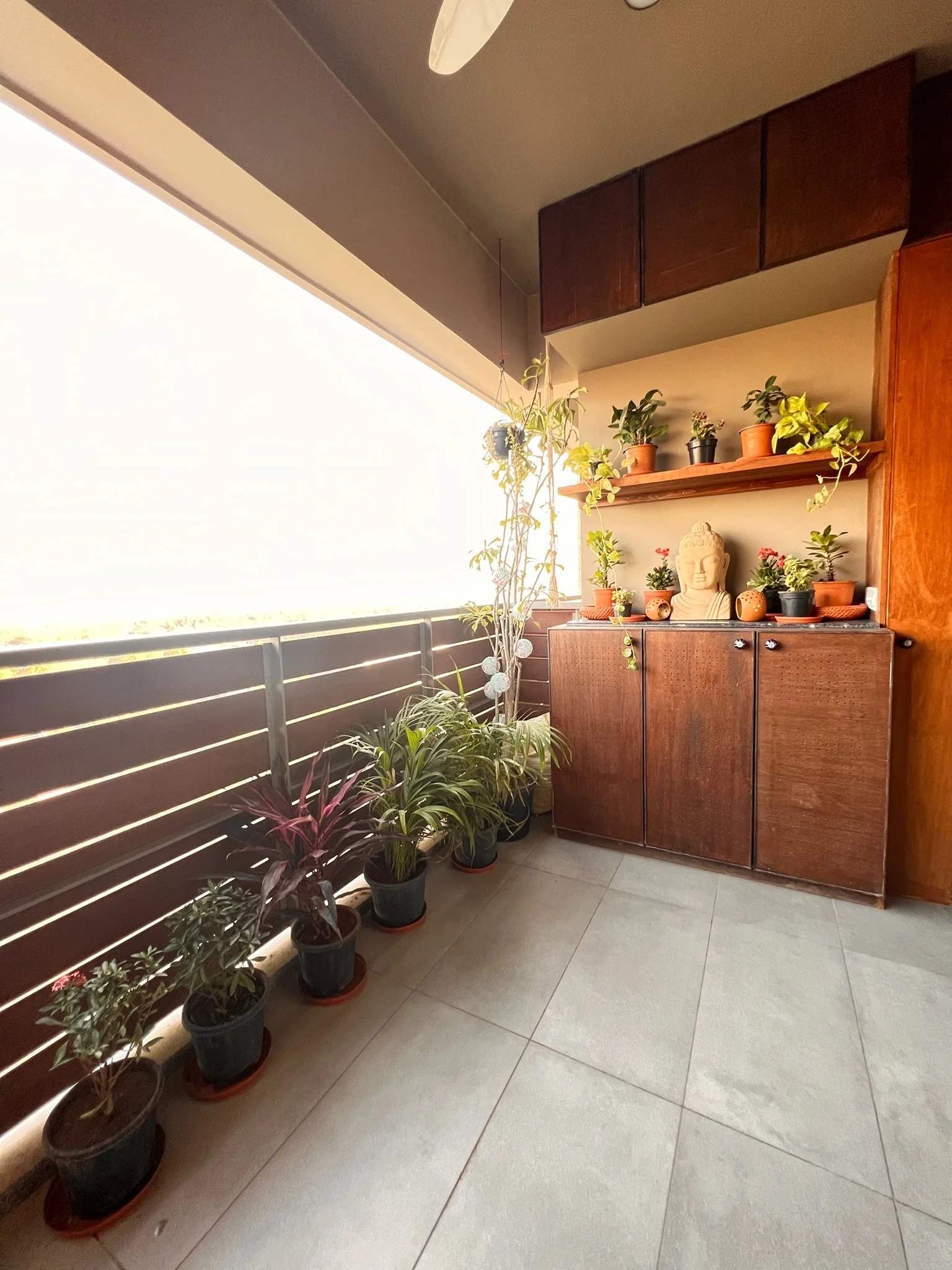Balcony garden with Buddha and potted plants