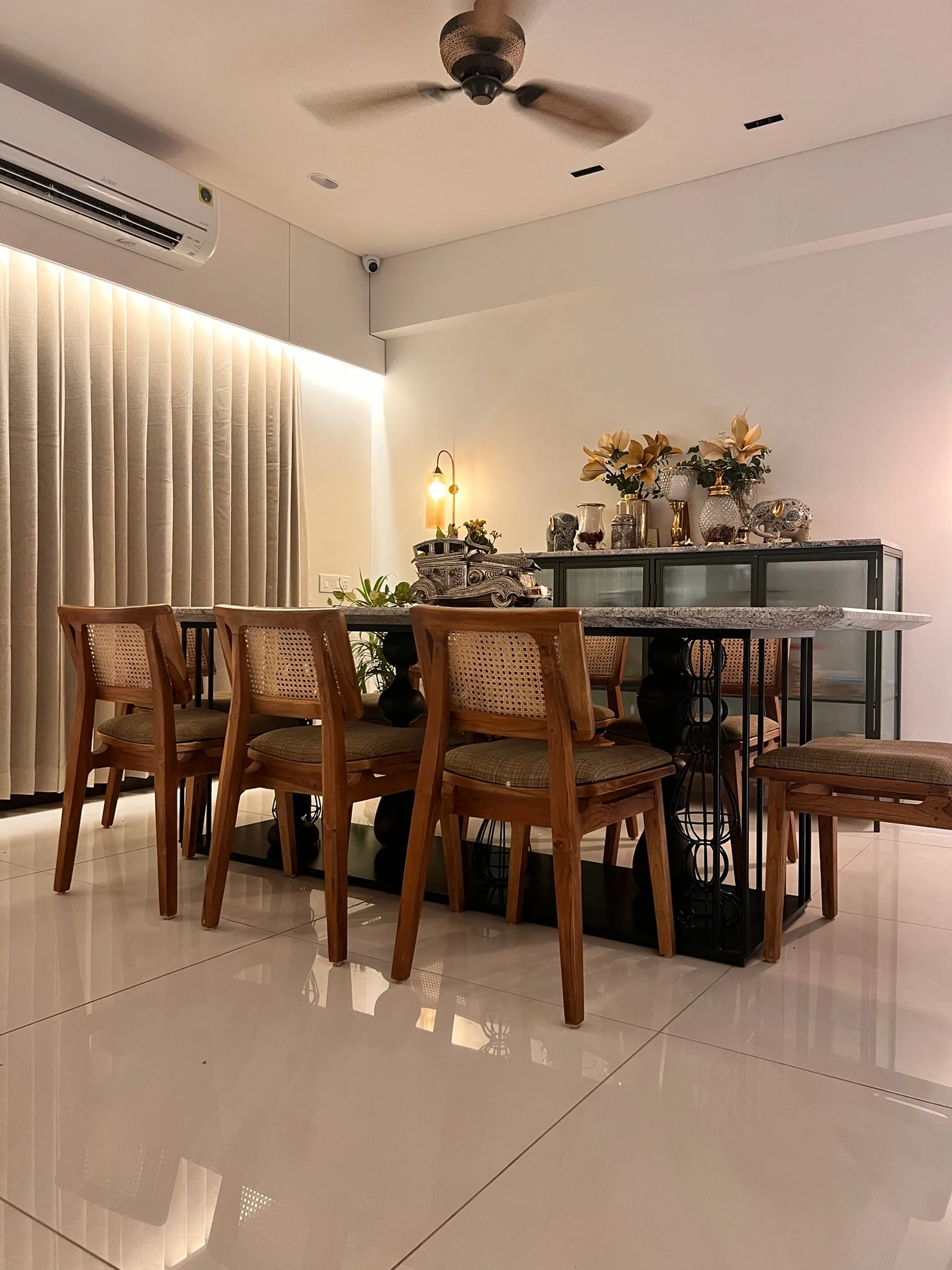 Dining room with cane chairs and brass console