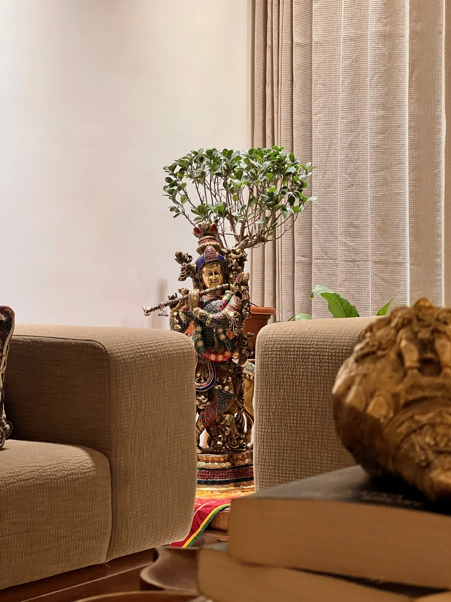 The Home — warm open-plan living with brass accents and artisanal décor