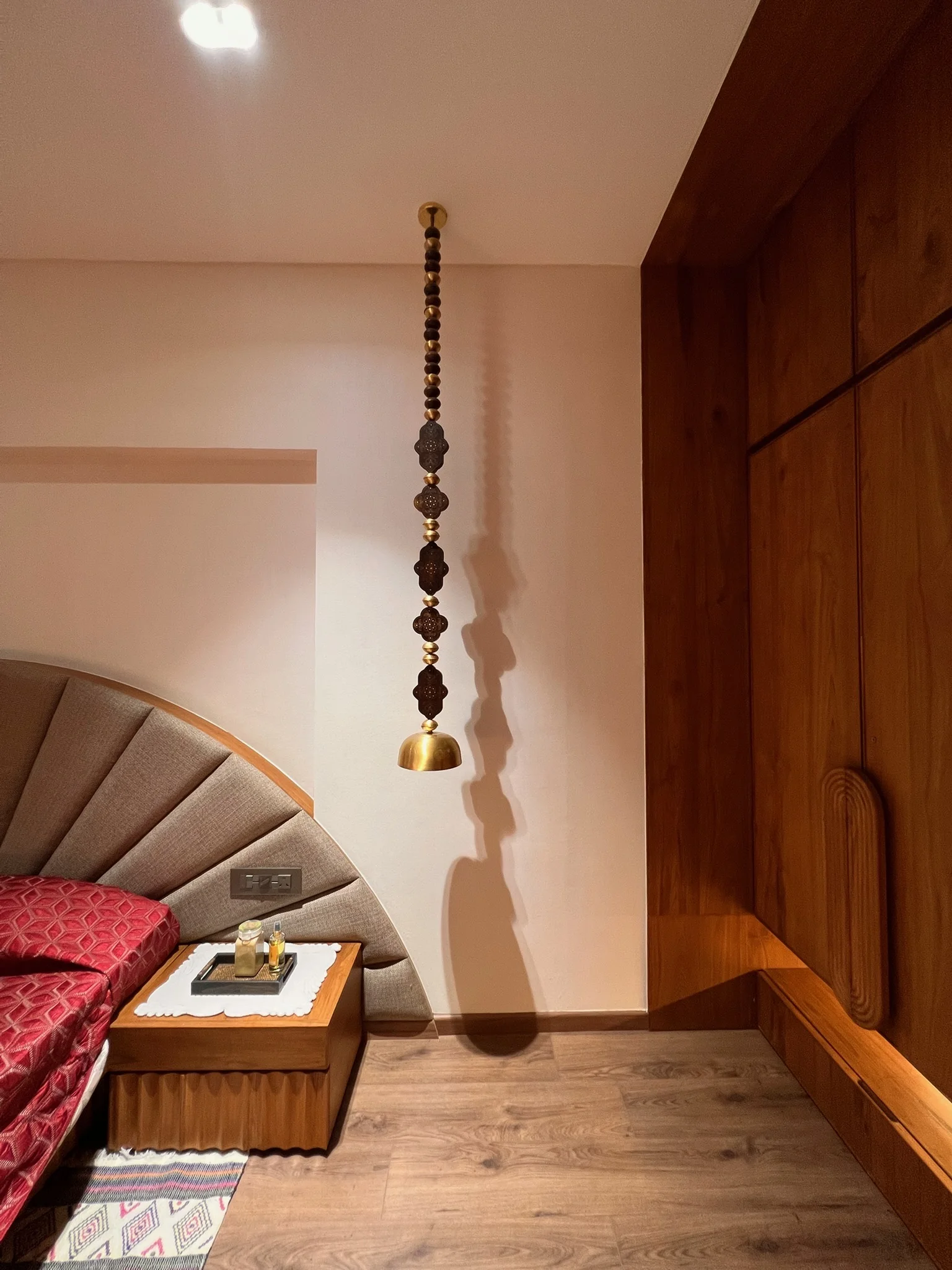Master bedroom fan headboard with brass pendant