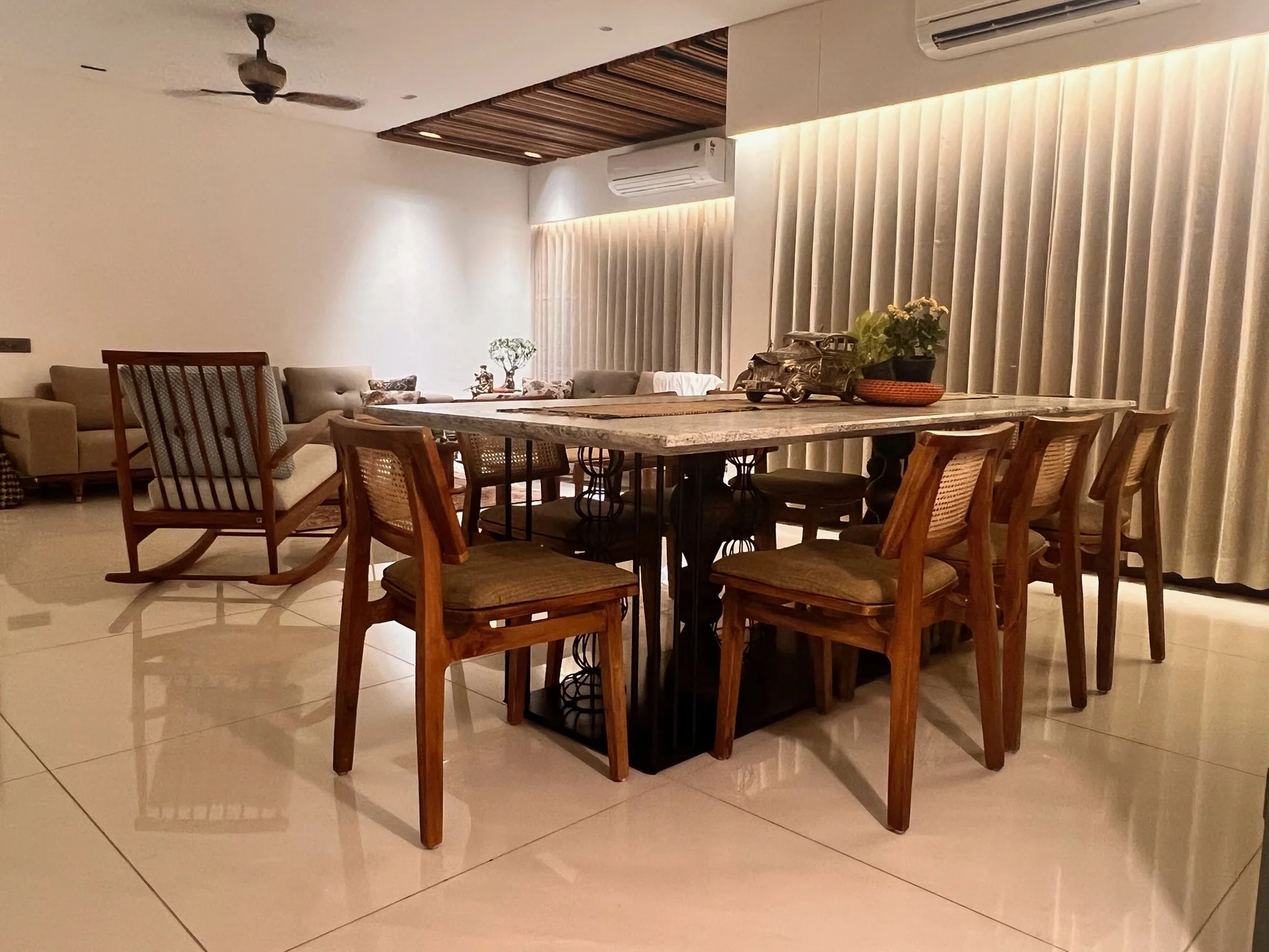 Open dining and living room with cane chairs
